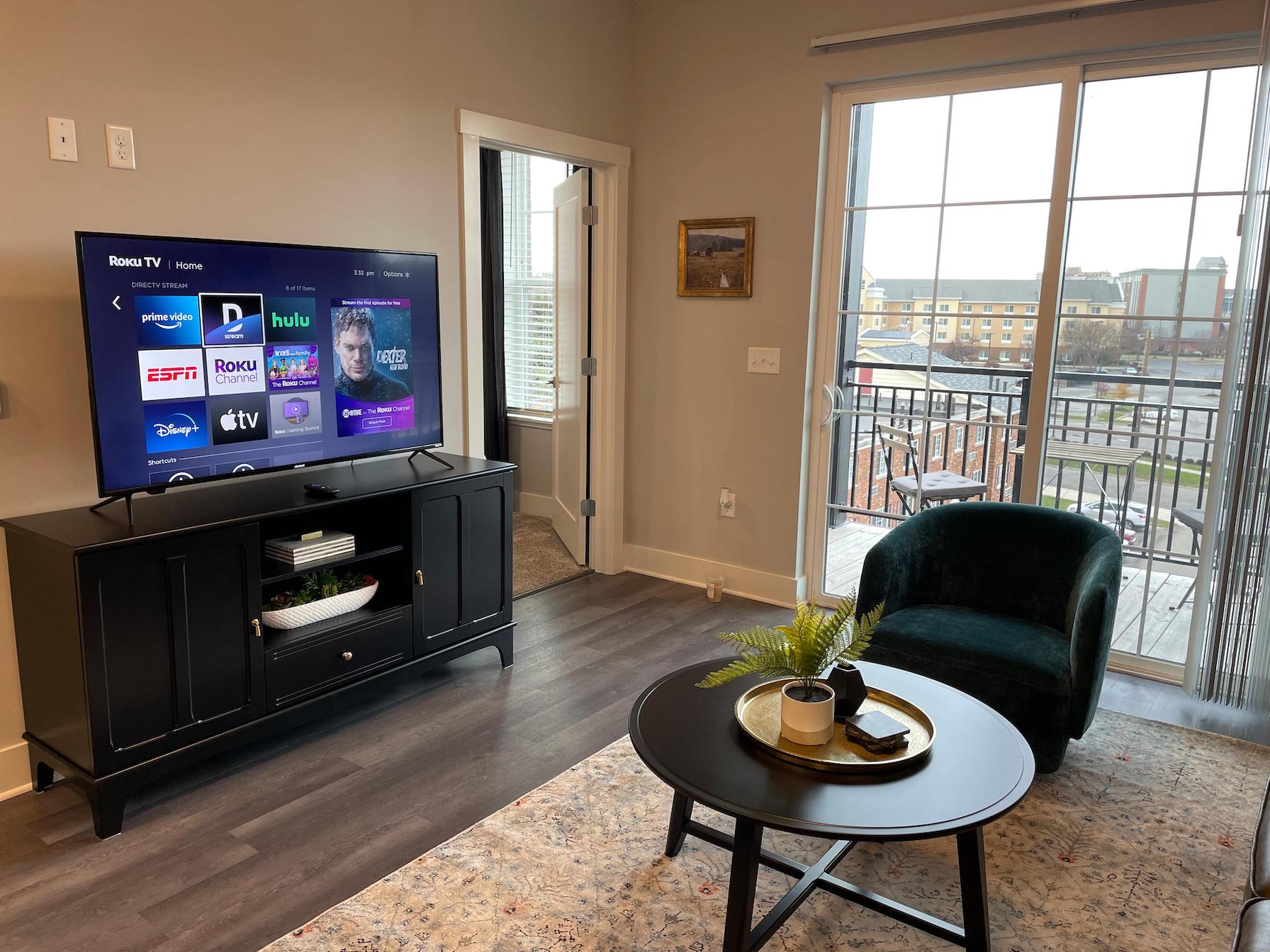 Living room with a smart tv in a furnished apartment near Ohio State