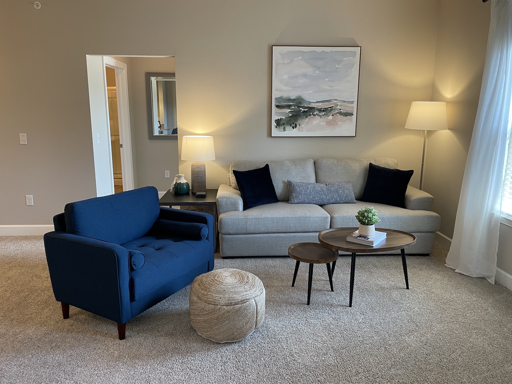 Living room with couch, coffee table and side chair in a furnished apartment near Westerville Ohio