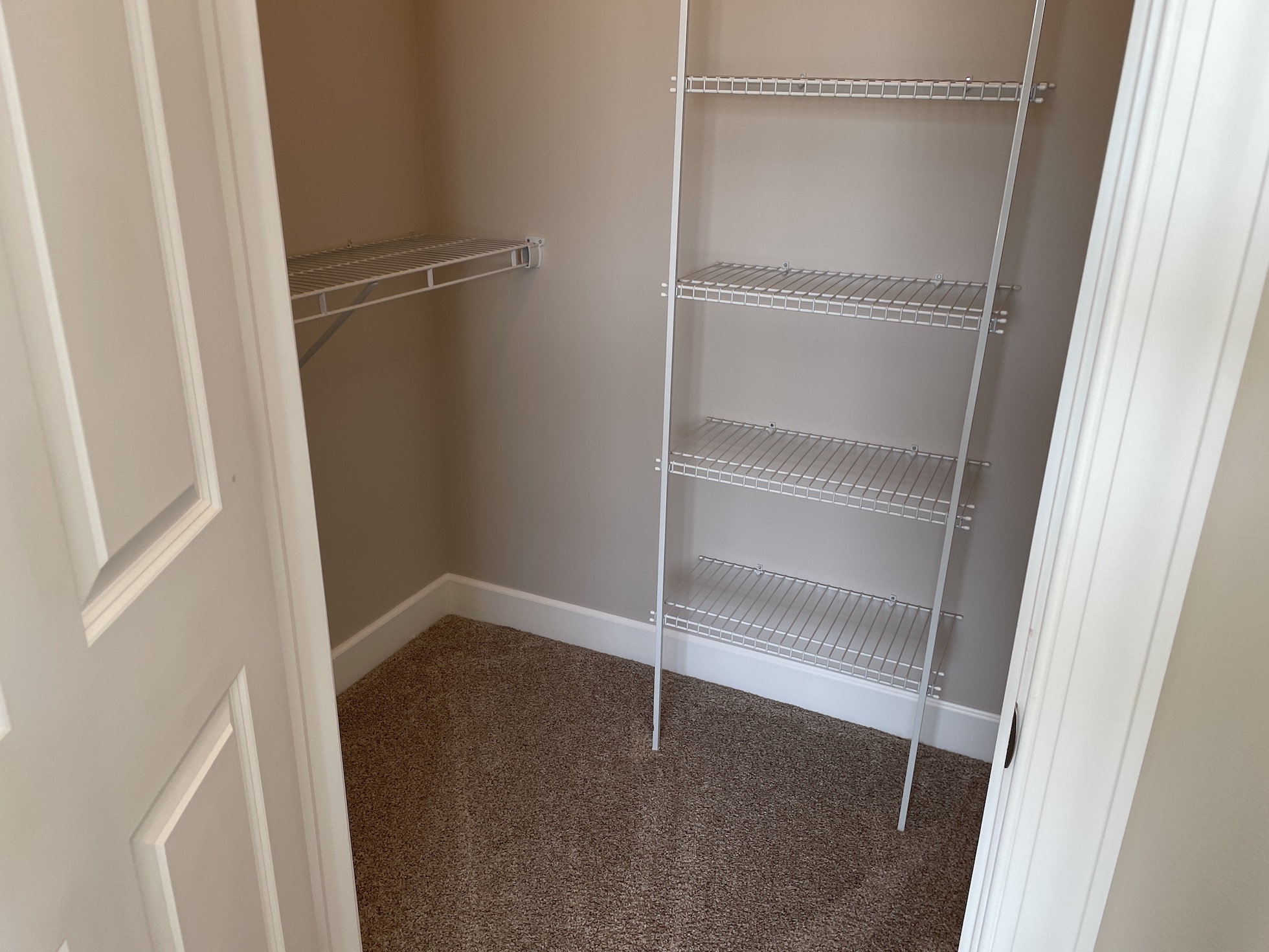 A walk-in closet with hangers in a furnished apartment in Westerville Ohio