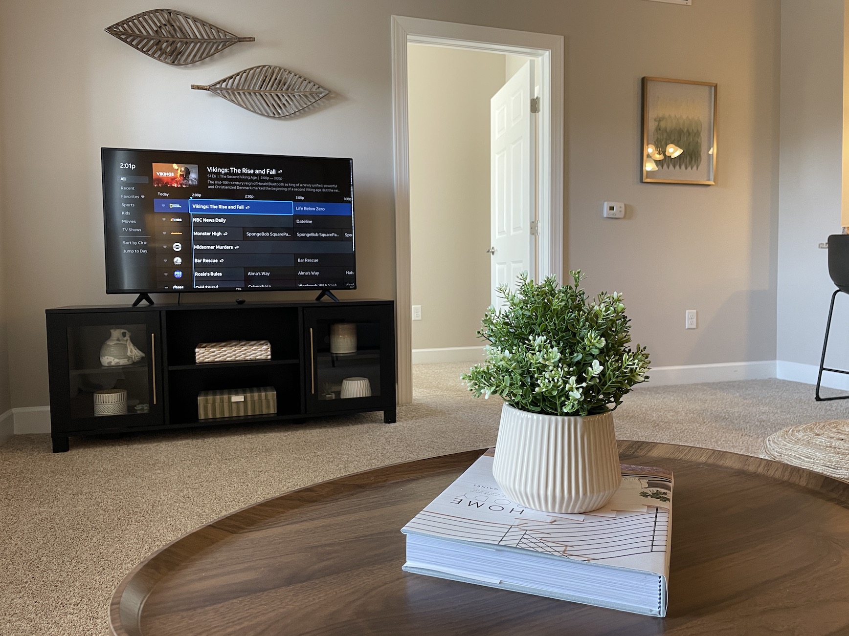 Living room with a smart TV and a coffee table, in a furnished apartment in Westerville Ohio