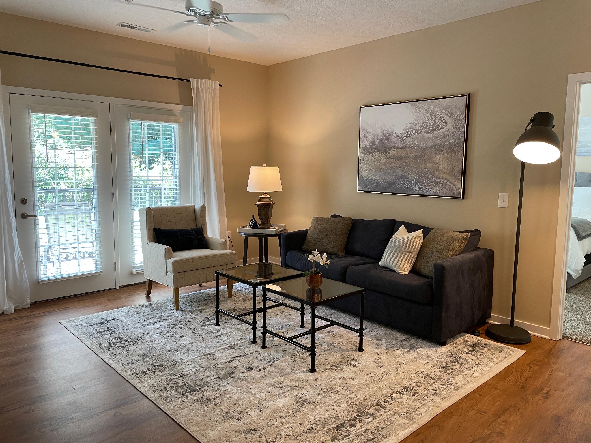 Living room with couch, coffee table and side chair in a furnished apartment near New Albany Ohio