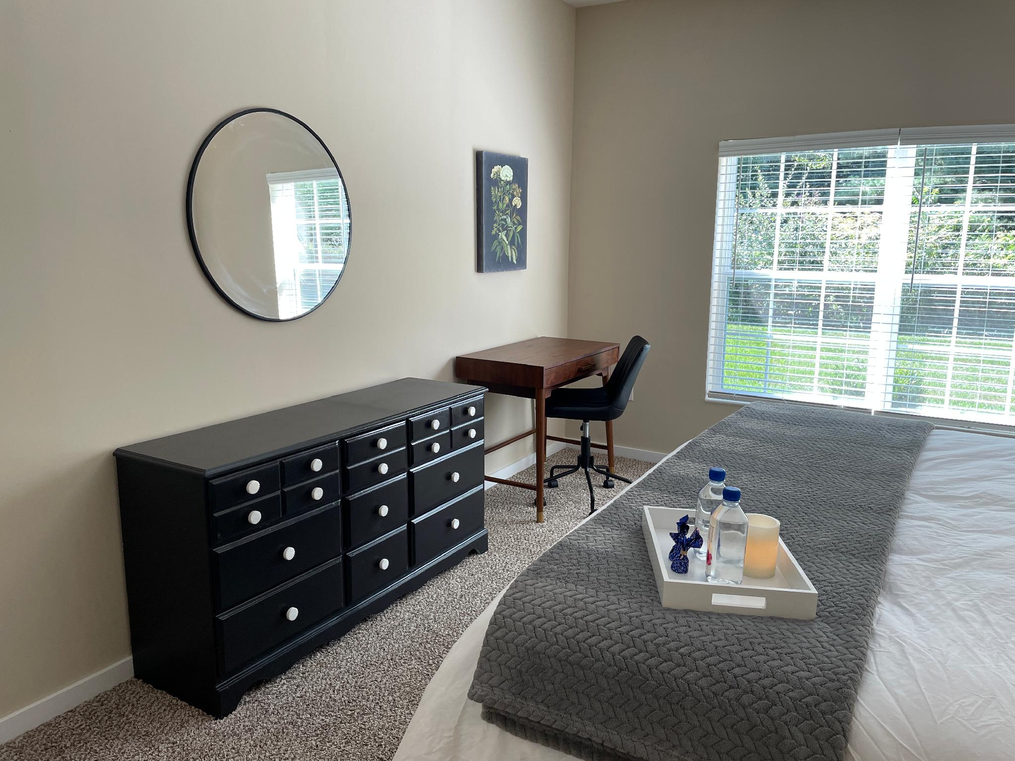 King bed with dresser, mirror, and desk and desk chair in a furnished apartment near New Albany Ohio