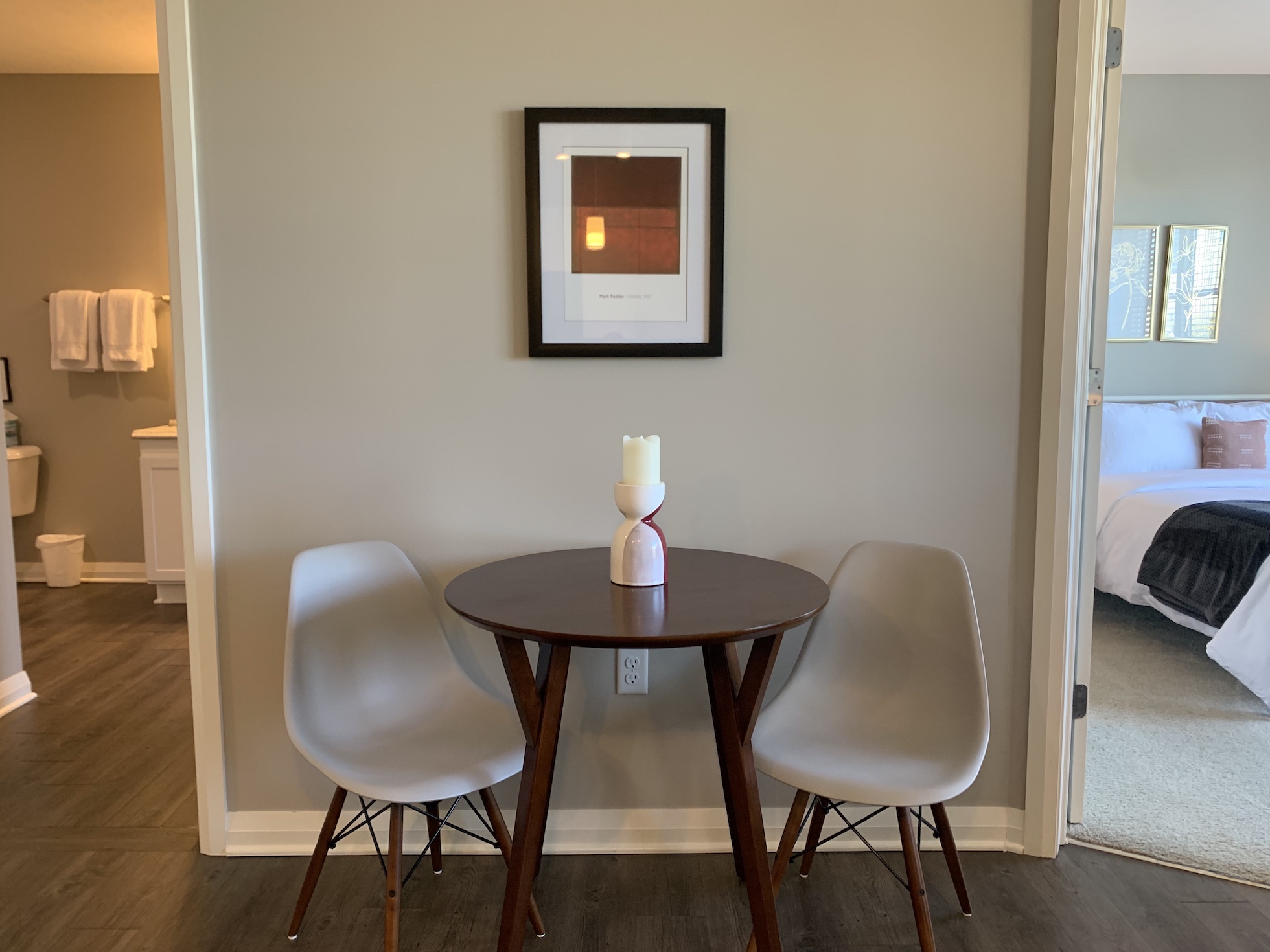 Dining table and chairs next to a wall with art in a furnished apartment in Downtown Columbus