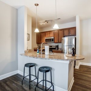 A fully stocked kitchen in a furnished apartment in Westerville Ohio with counter stools and decor