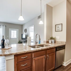 A kitchen counter with a sink and dishwasher in a furnished apartment in Westerville Ohio