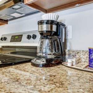 A drip coffee maker, coffee, and tea supplies on the counter of a furnished apartment in Westerville Ohio