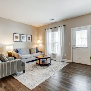 Living room with couch, coffee table and side chair in a furnished apartment in Westerville Ohio