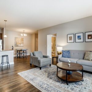 An open concept living space with a living room, dining area, and kitchen in a furnished apartment in Westerville Ohio