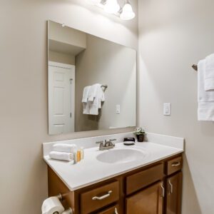 A bathroom vanity with a mirror in a furnished apartment in Westerville Ohio