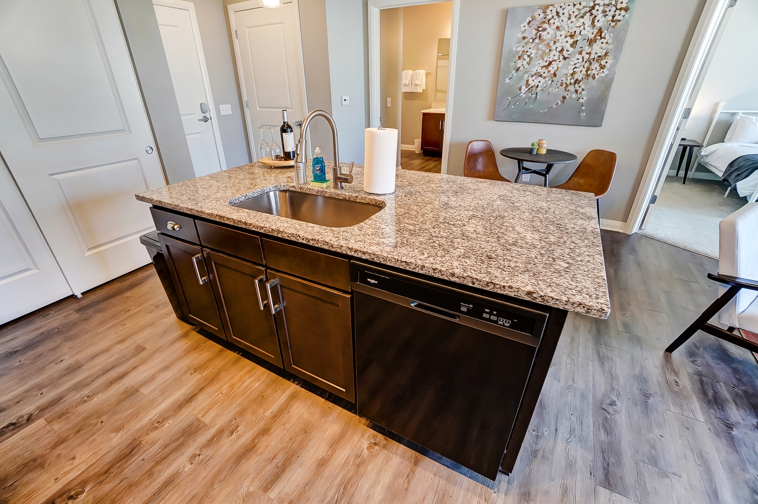 A kitchen island with a sink and dishwasher in a furnished apartment in Downtown Columbus