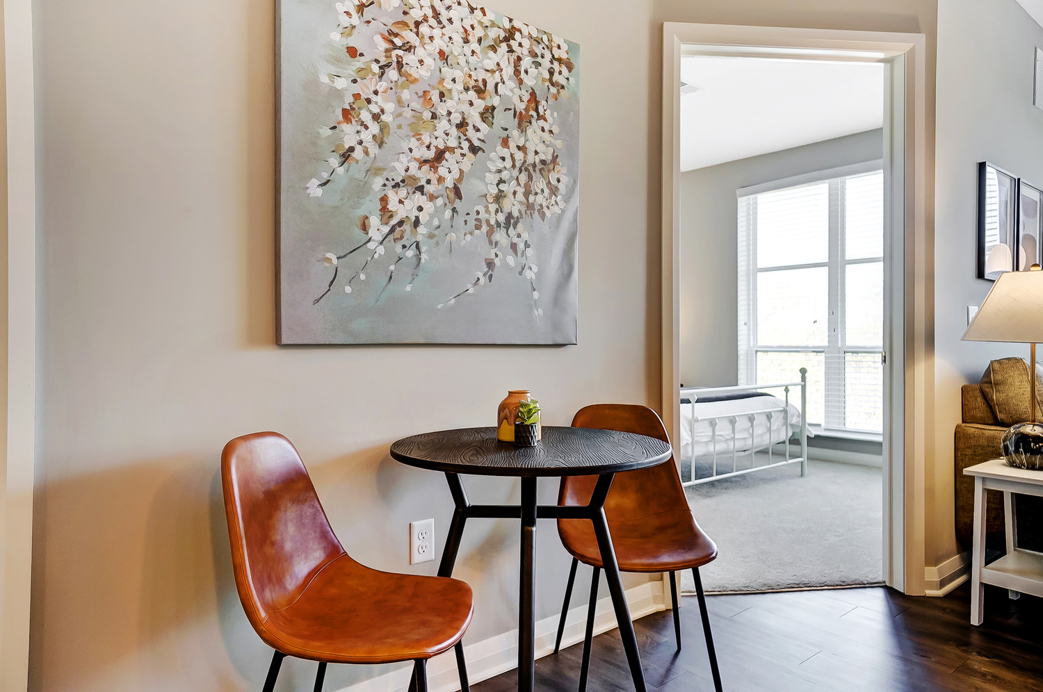 Dining table and chairs next to a wall with art in a furnished apartment in Downtown Columbus