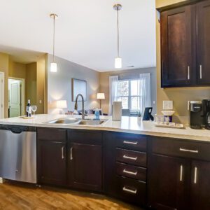 A kitchen counter with a sink and dishwasher in a furnished apartment in Hilliard Ohio