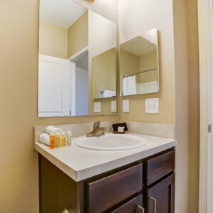 Bathroom vanity with toiletries, rolled wash cloths, and a soap dish in a furnished apartment in Hilliard Ohio