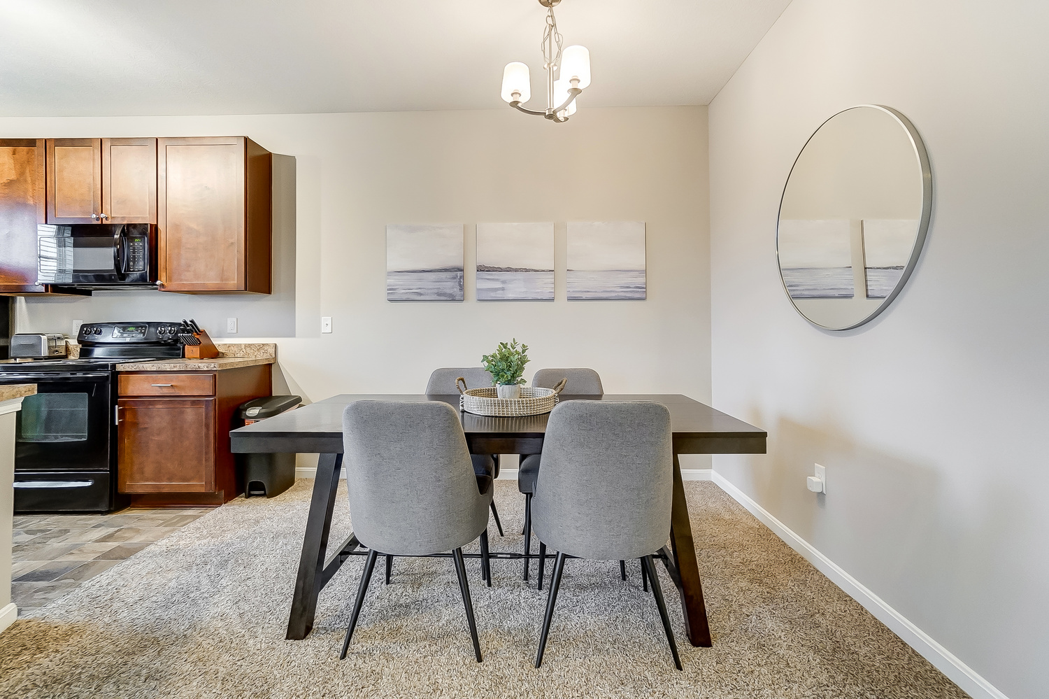 A wooden dining table with gray chairs in a furnished apartment near New Albany Ohio