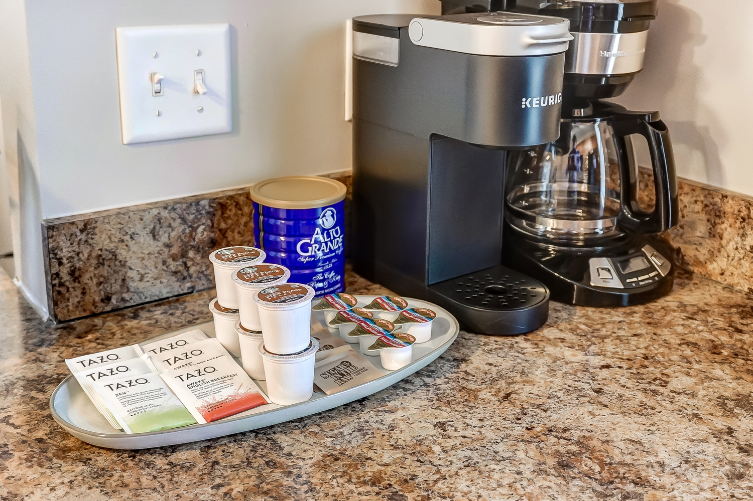 A keurig, drip coffee maker, and coffee and tea supplies on the counter of a furnished apartment near New Albany Ohio