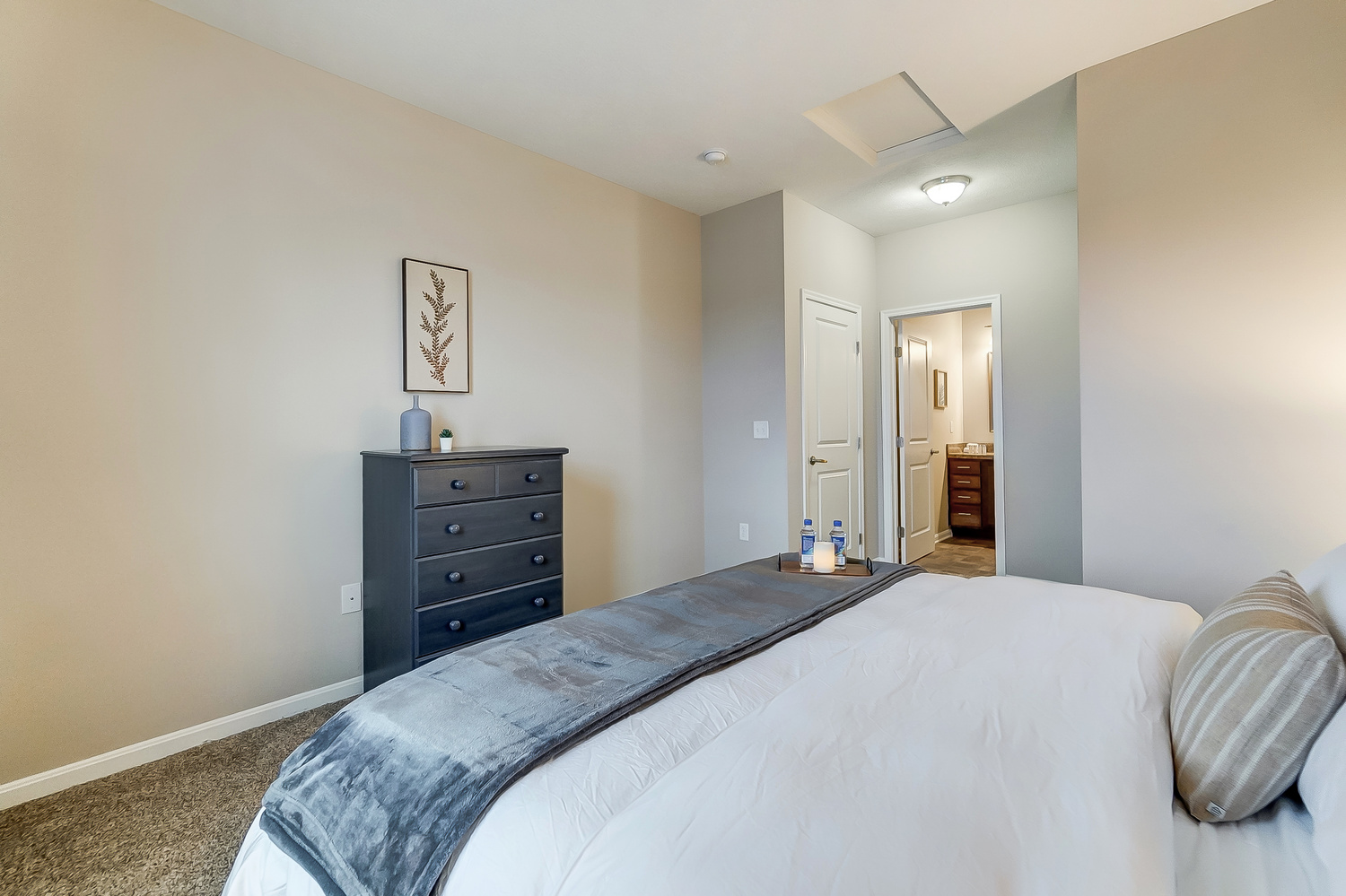 King bed and chest of drawers in the bedroom of a furnished apartment near New Albany Ohio