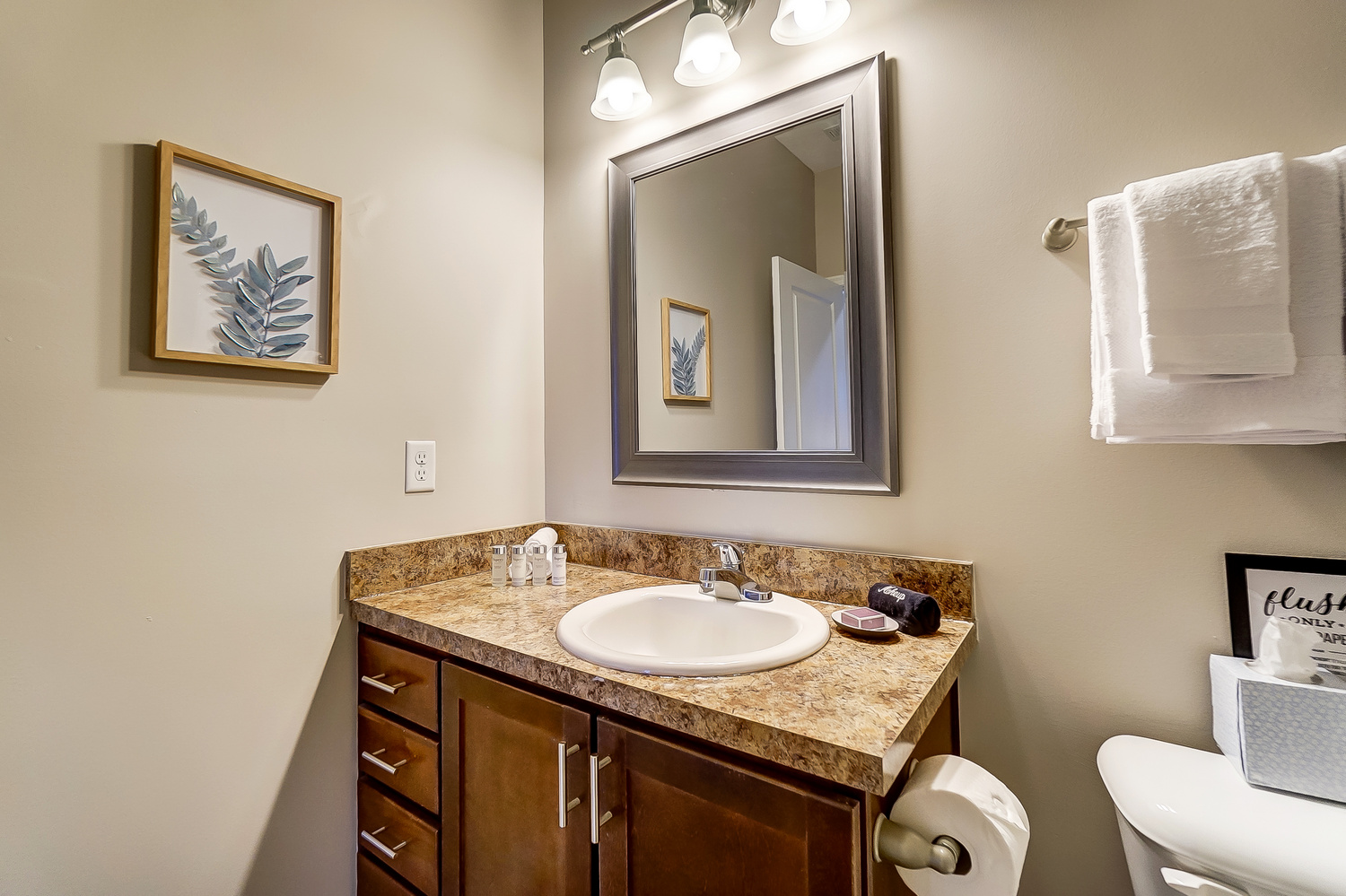 A bathroom vanity with a mirror in a furnished apartment near New Albany Ohio