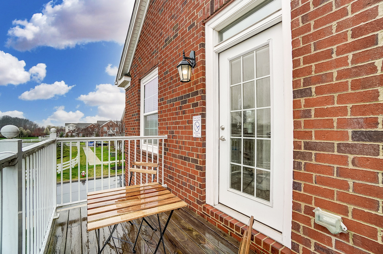 A balcony with outdoor furniture in a furnished apartment near New Albany Ohio