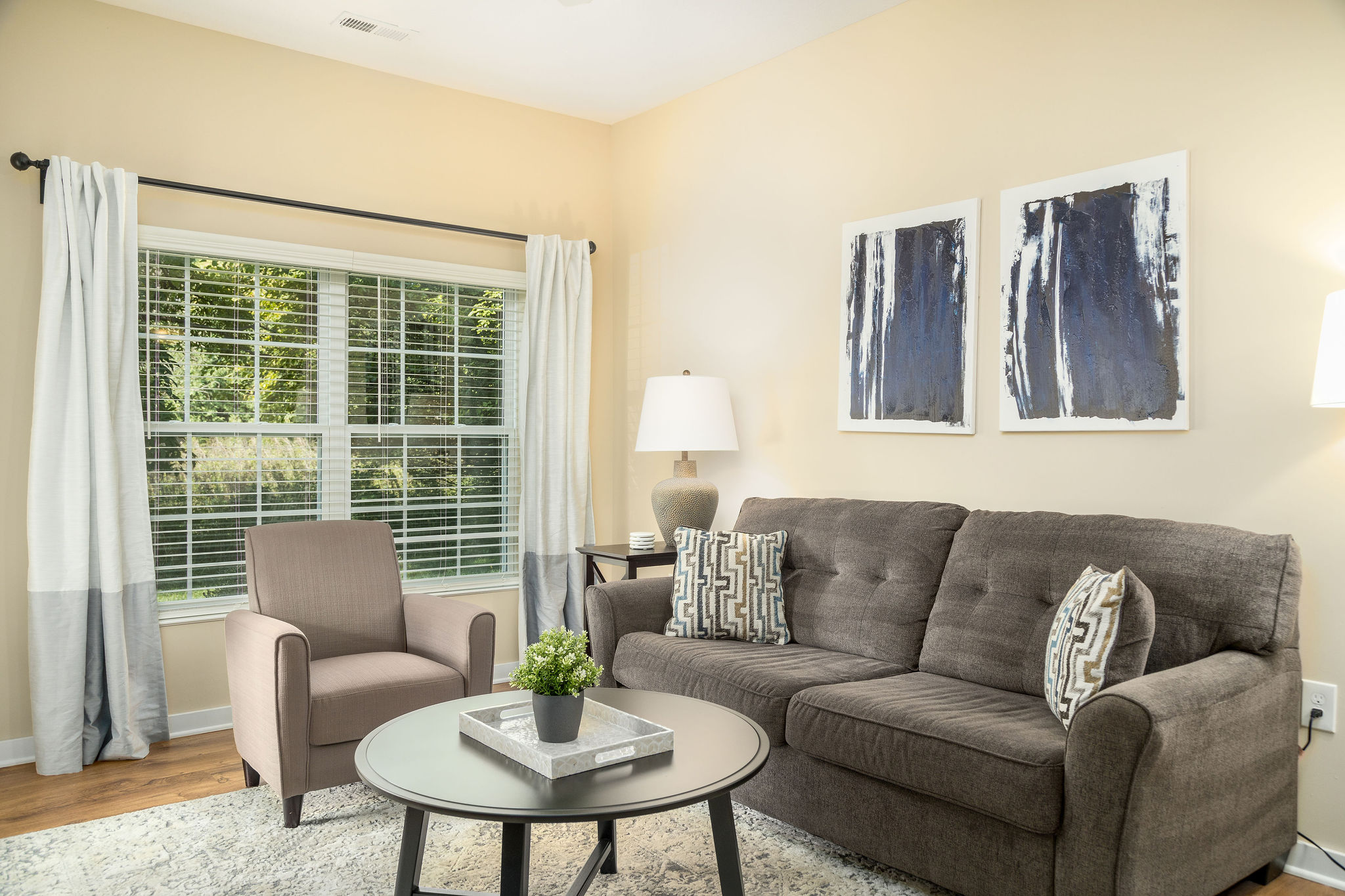 Living room with couch, coffee table and side chair in a furnished apartment near New Albany Ohio