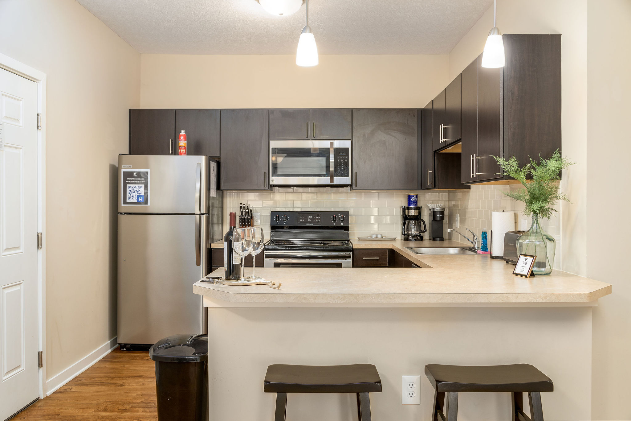 A kitchen in a furnished apartment near New Albany Ohio with counter stools and decor