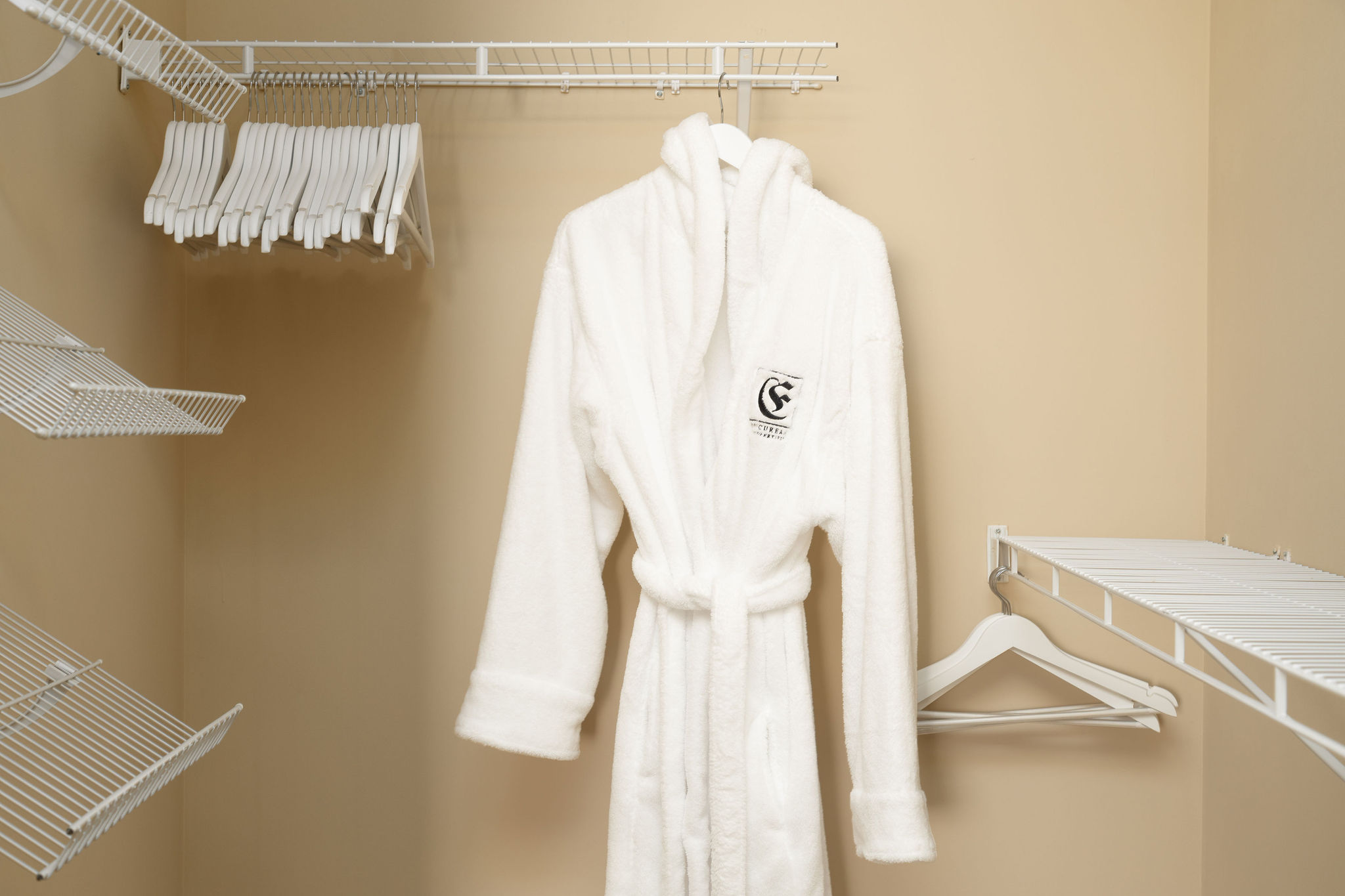 An Epicurean Properties branded robe hanging in the closet of a furnished apartment near New Albany Ohio