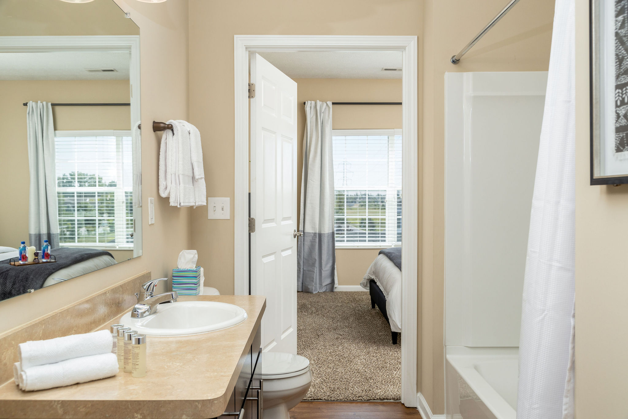 A bathroom with toiletries and towels in a furnished apartment near New Albany Ohio