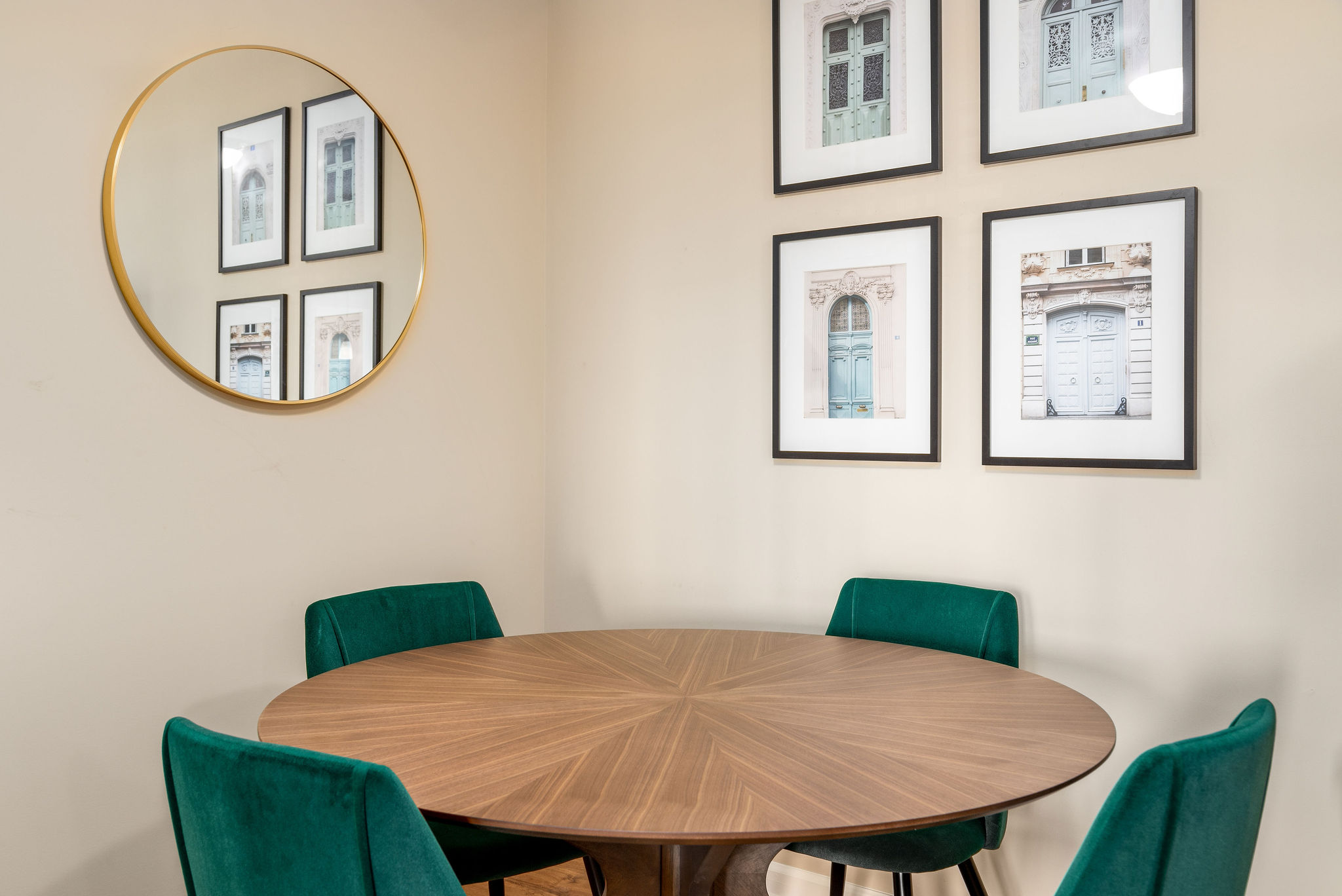 A wooden dining table with green velvet chairs in a furnished apartment near New Albany Ohio