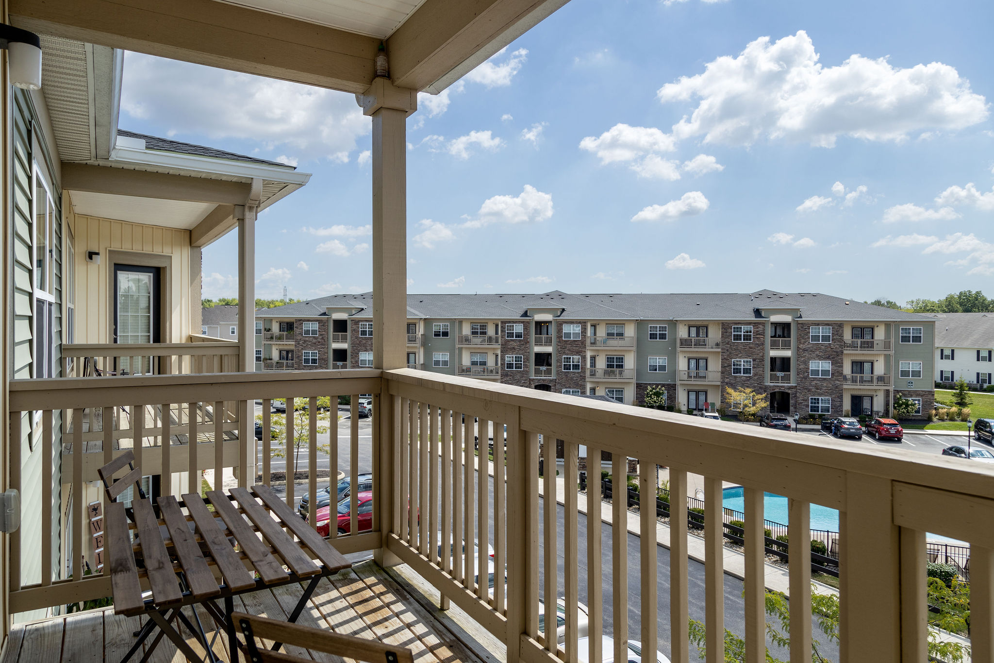 The balcony of a furnished apartment near New Albany Ohio overlooking a pool