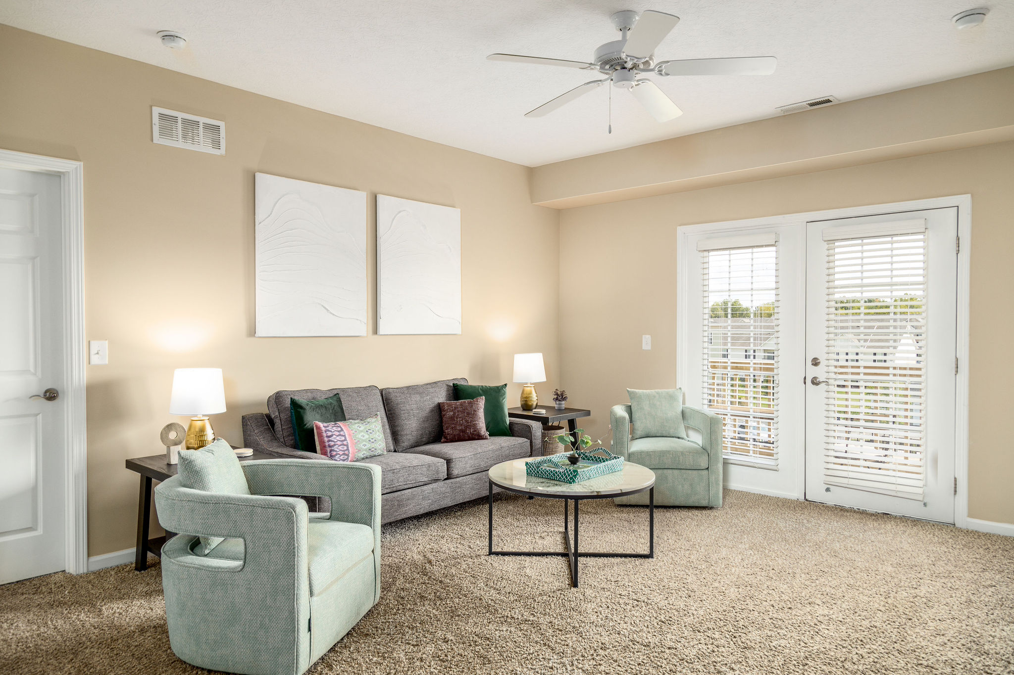 A living room with a couch, chairs, and a coffee table in a furnished apartment near New Albany Ohio