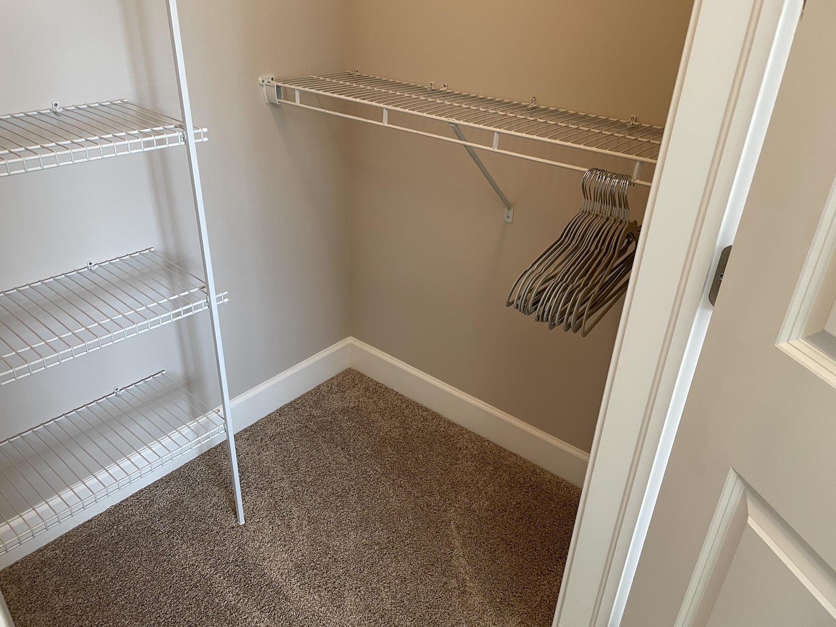 A walk-in closet with hangers in a furnished apartment in Westerville Ohio