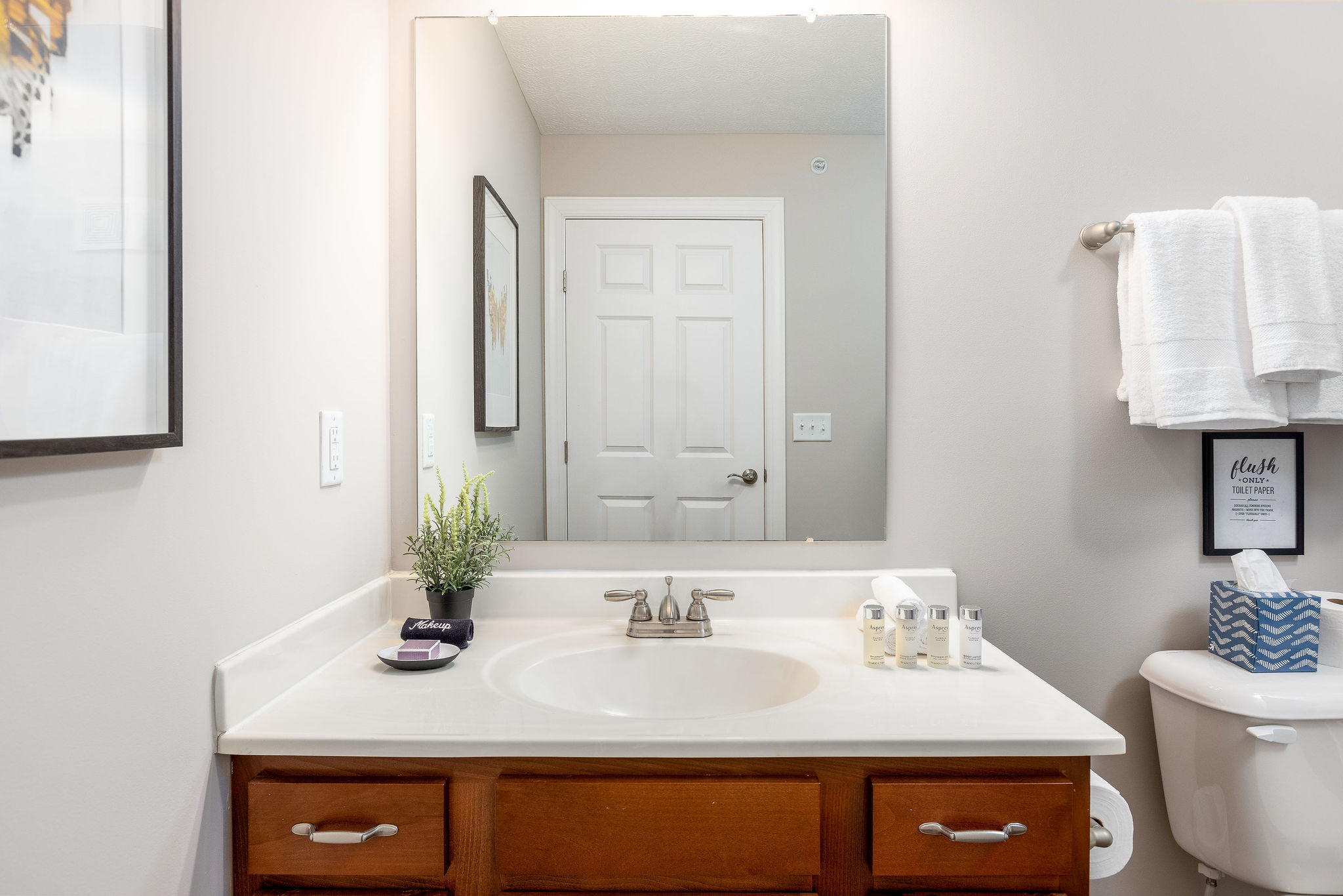 A bathroom vanity with a mirror in a furnished apartment in Westerville Ohio