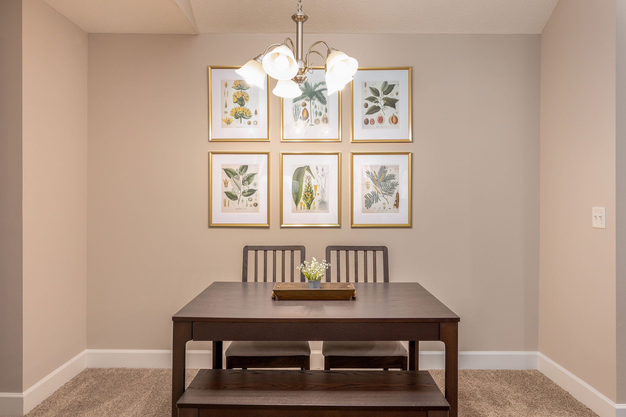 A dining area with a dining table and wall art in a furnished apartment near Westerville Ohio