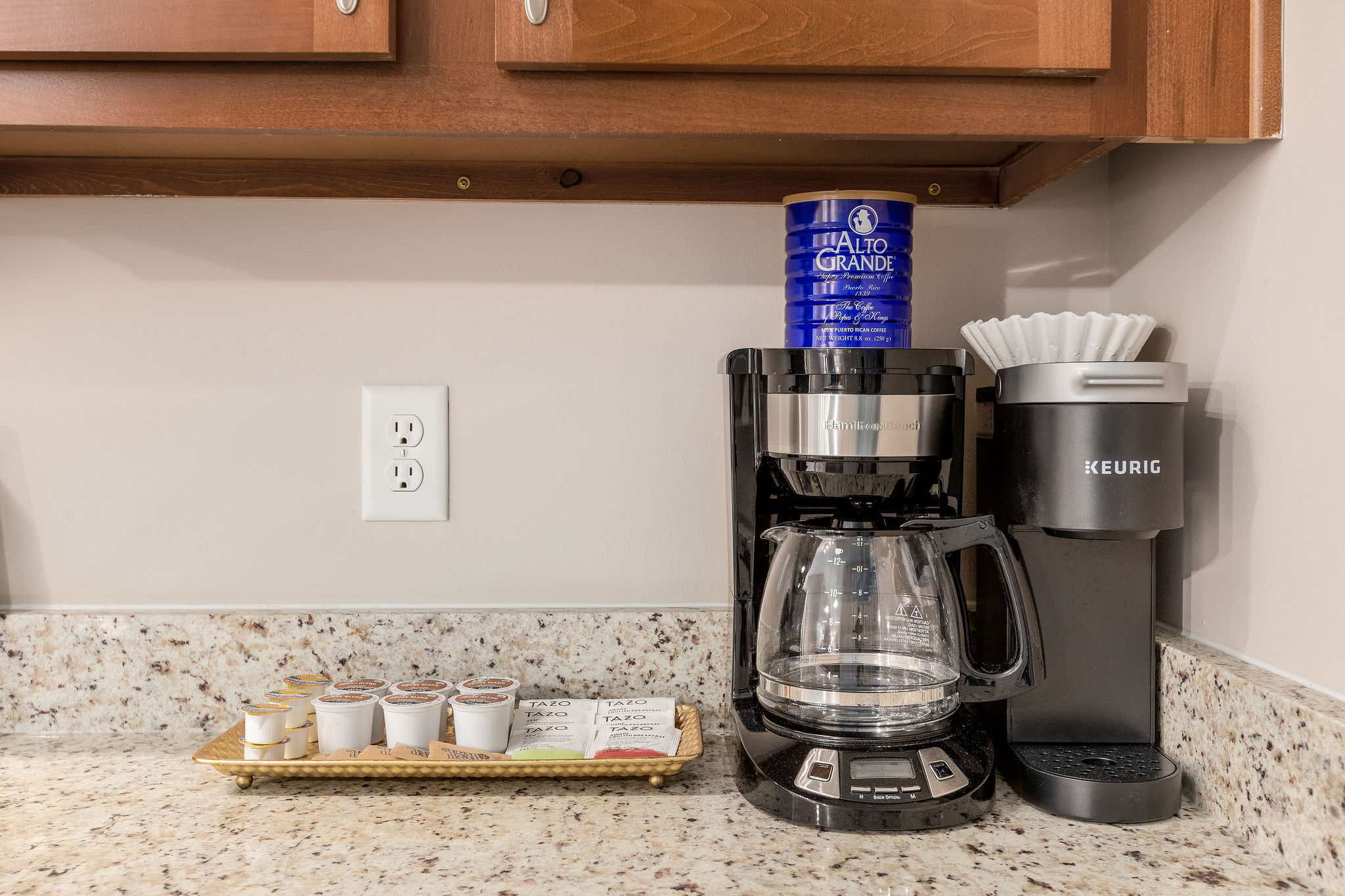 A drip coffee maker, Keurig, coffee, and tea supplies on the counter of a furnished apartment in Westerville Ohio