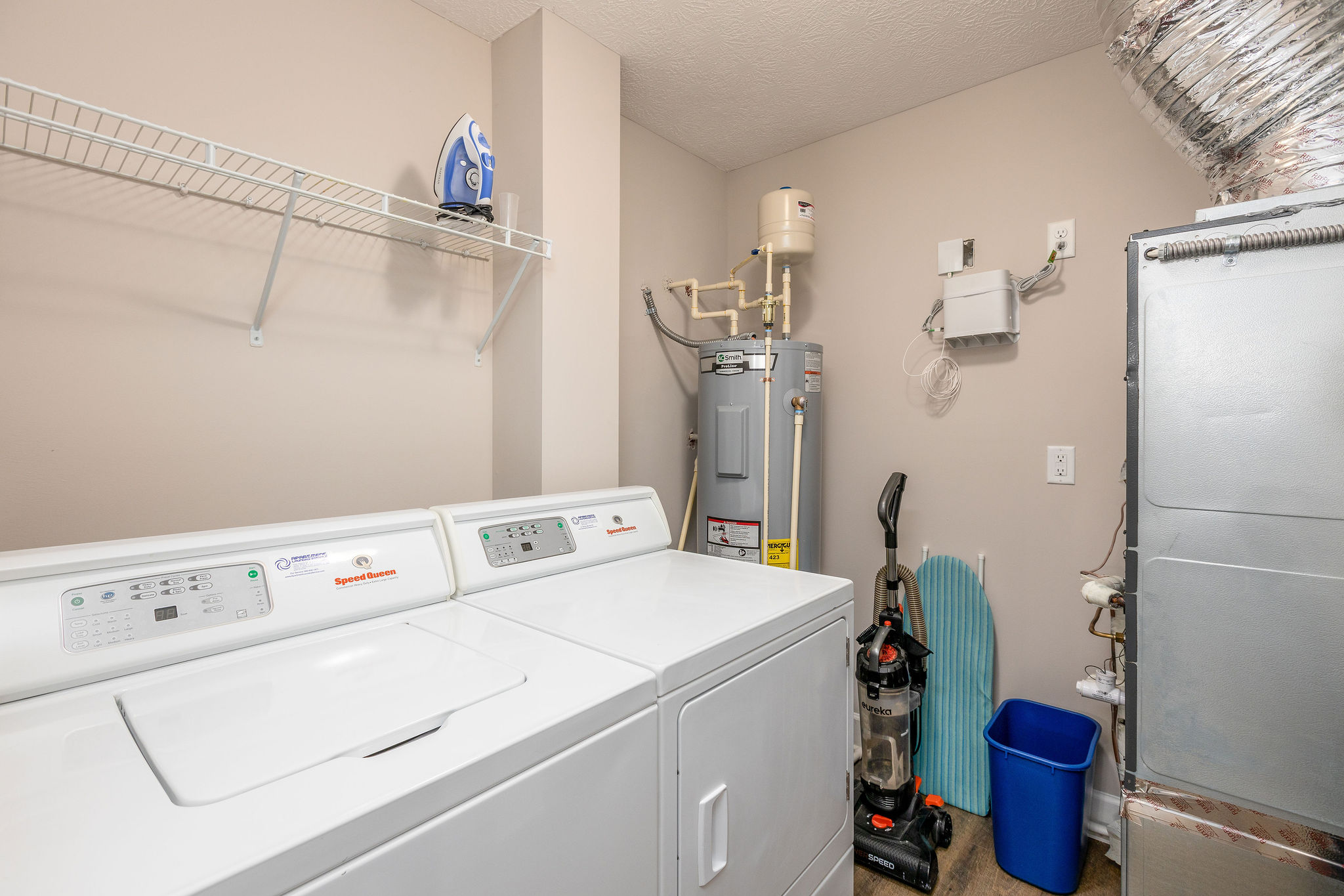 Laundry room with a full size washer and dryer in a furnished apartment in Westerville Ohio