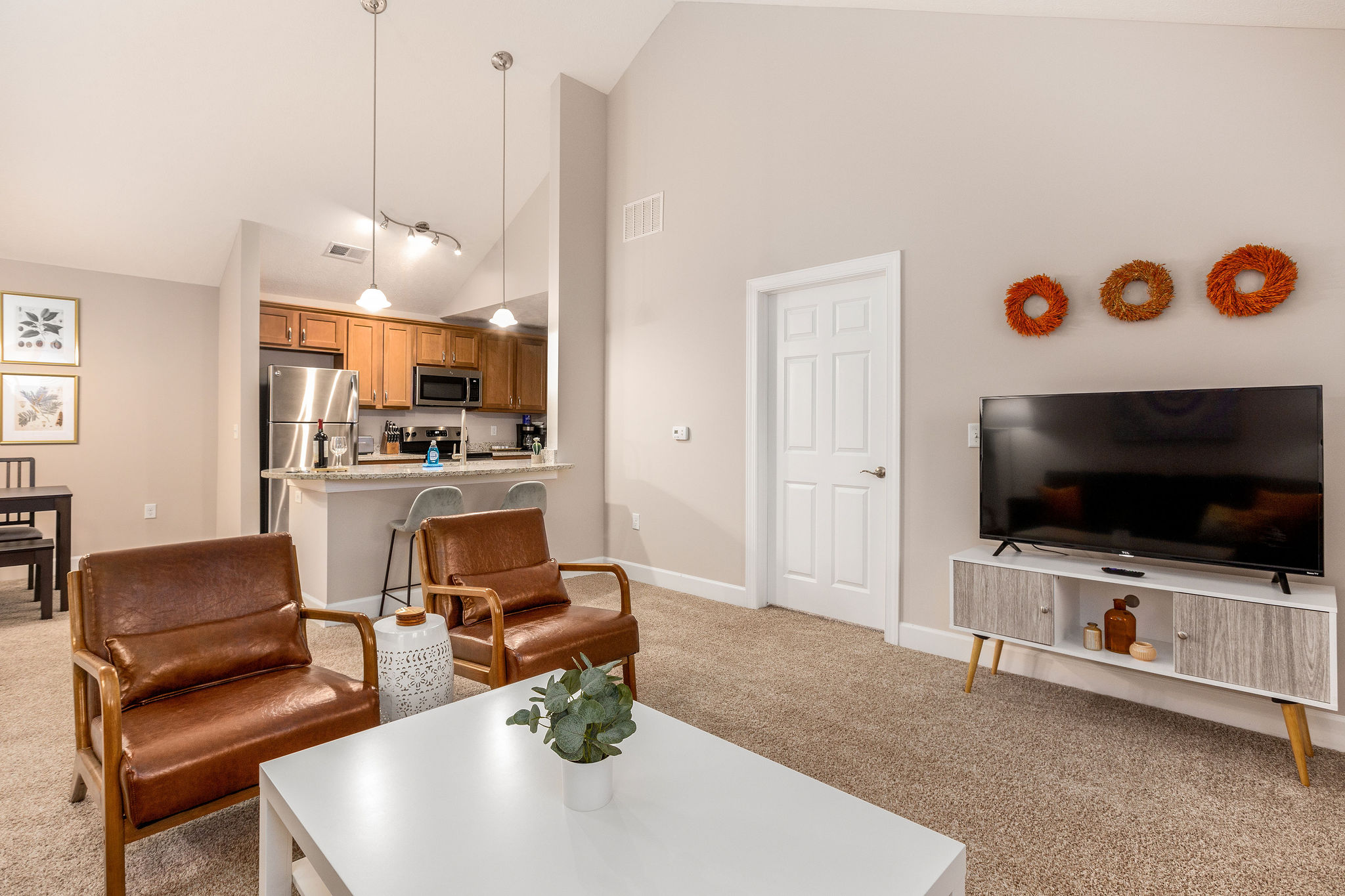 An open concept living space with a living room, dining area, and kitchen in a furnished apartment in Westerville Ohio