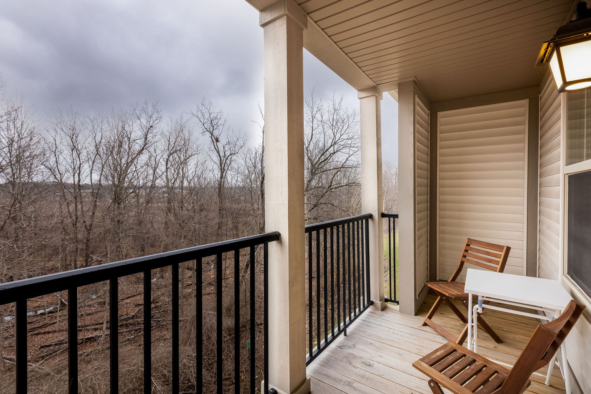 Outdoor balcony of a furnished apartment in Westerville Ohio overlooking woods