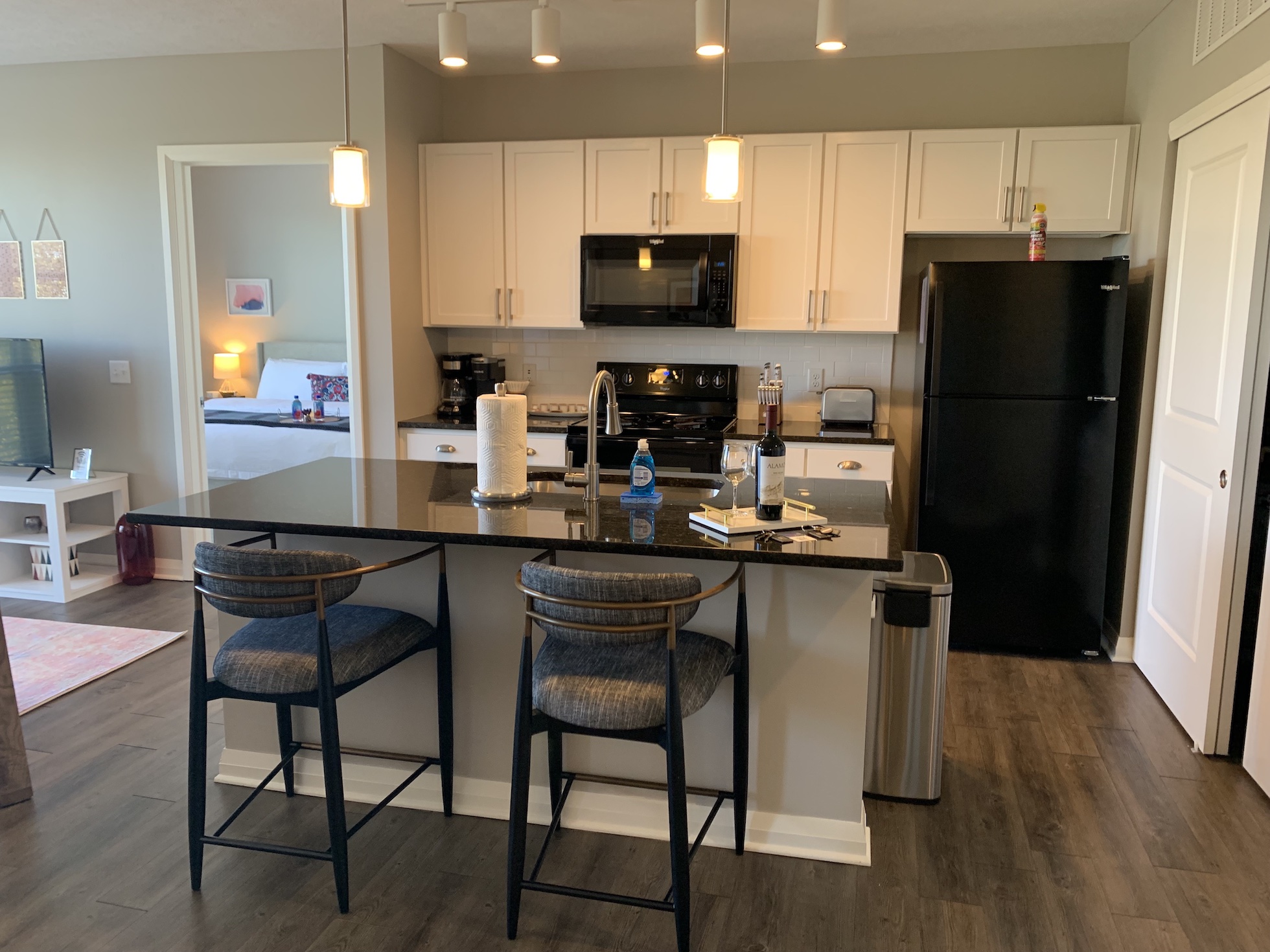 A fully stocked kitchen in a furnished apartment in Downtown Columbus with counter stools