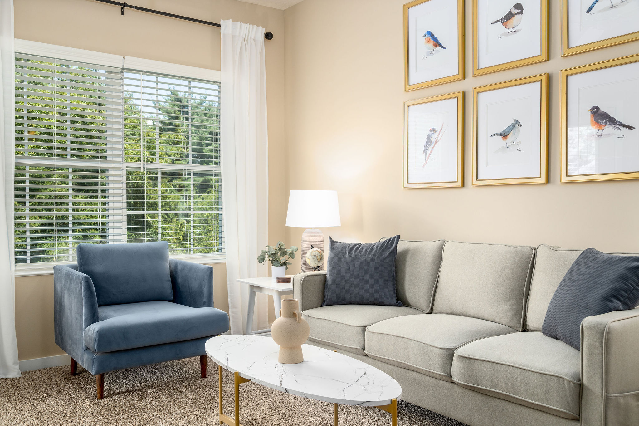 Living room with couch, coffee table and side chair in a furnished apartment near New Albany Ohio