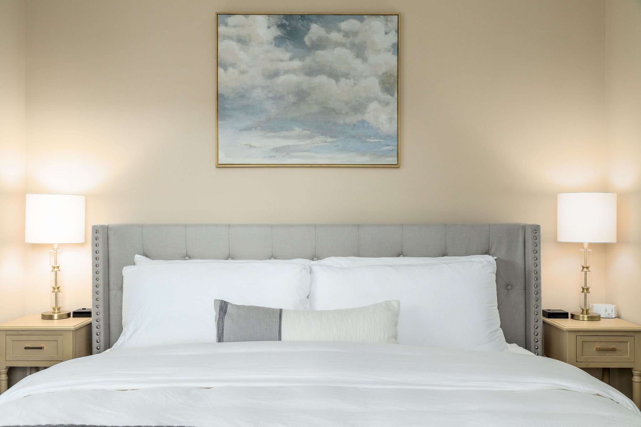 Cloud art hanging above a king bed in a furnished apartment near New Albany Ohio