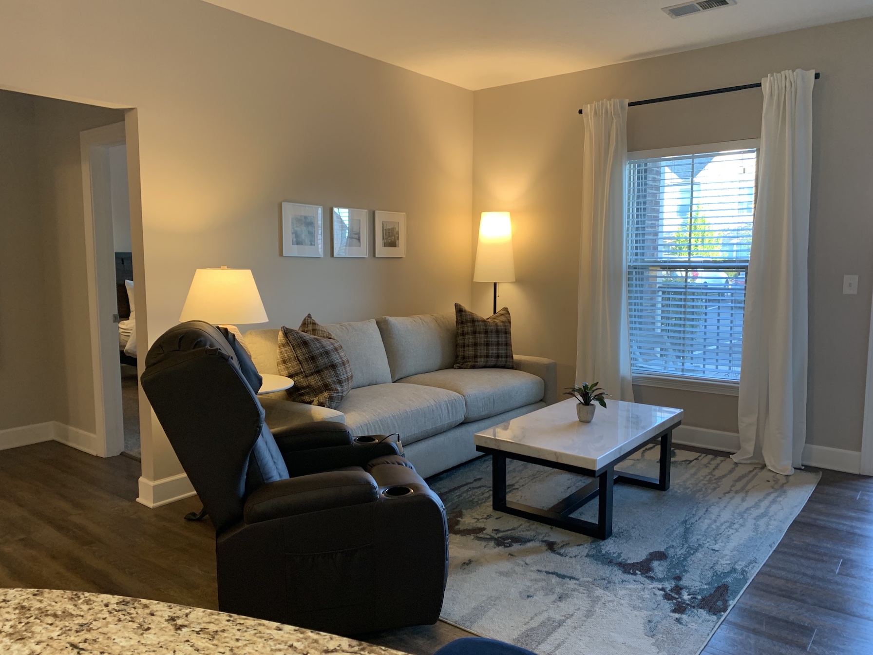 Living room with couch, coffee table and chair in a furnished apartment in Westerville Ohio