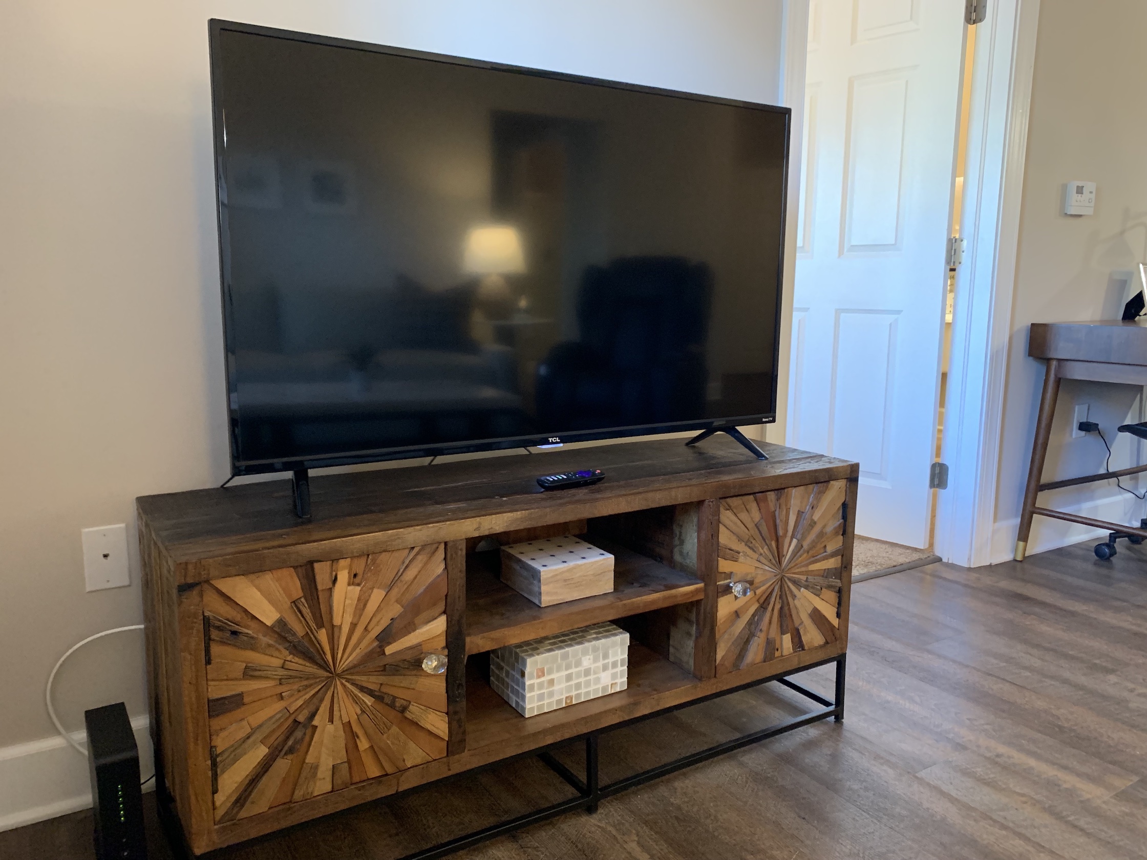 Smart TV on a wooden tv stand in a furnished apartment in Westerville Ohio