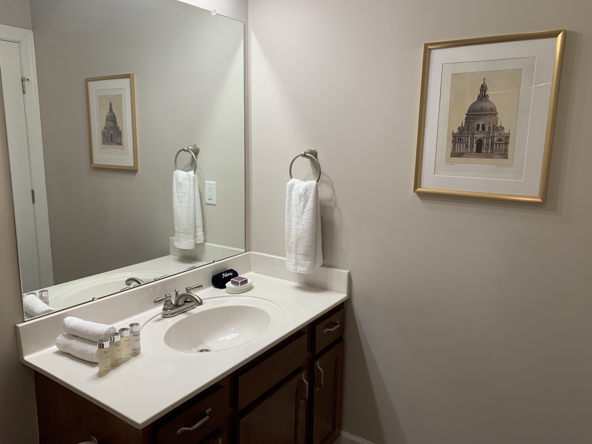 A bathroom vanity with a mirror in a furnished apartment in Westerville Ohio