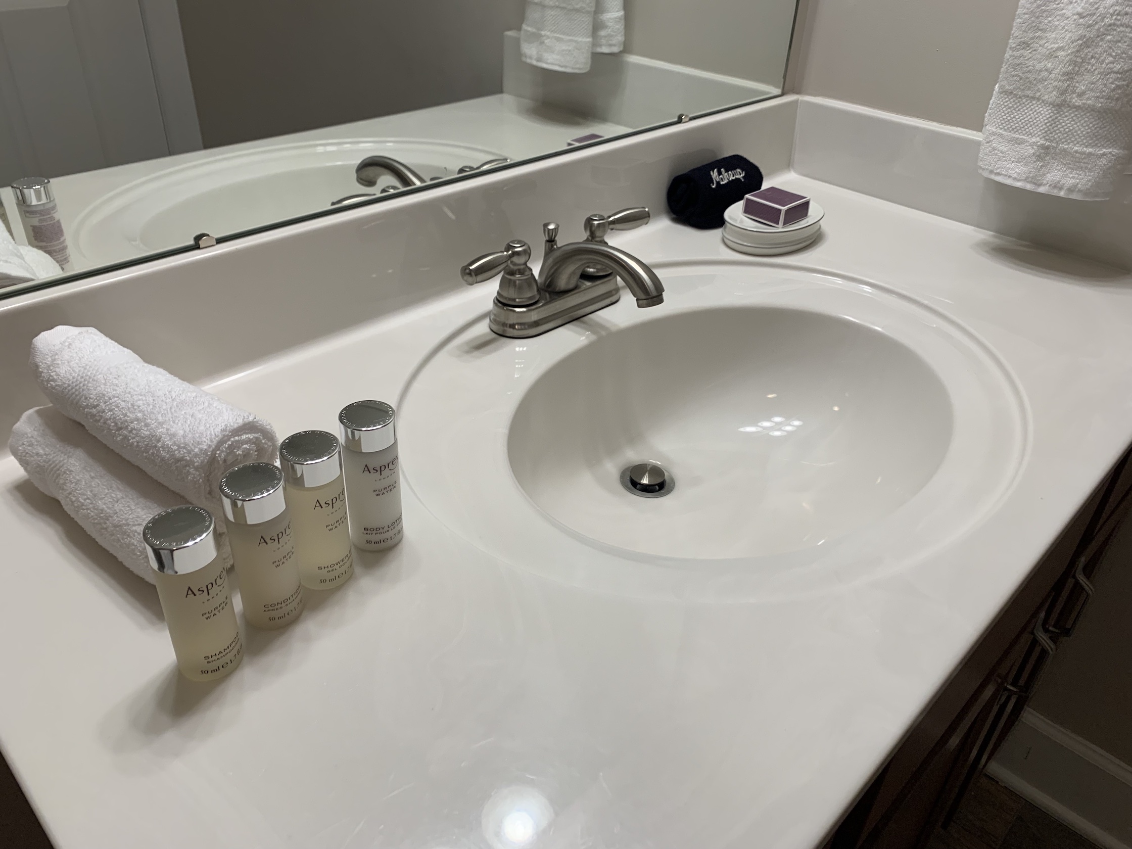 A bathroom vanity with a mirror in a furnished apartment in Westerville Ohio