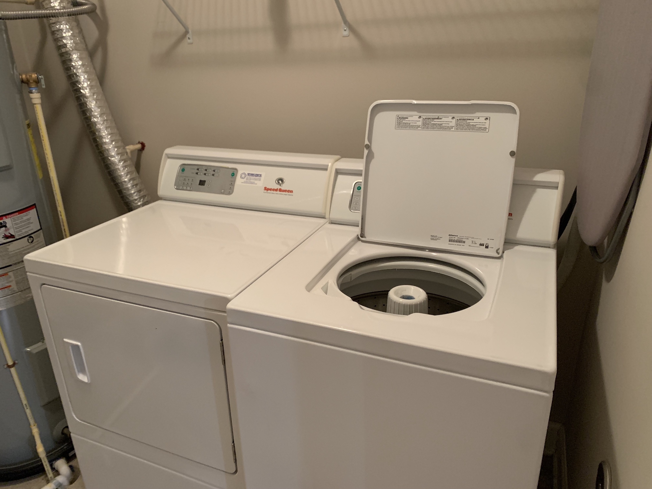 Laundry room with a full size washer and dryer in a furnished apartment in Westerville Ohio