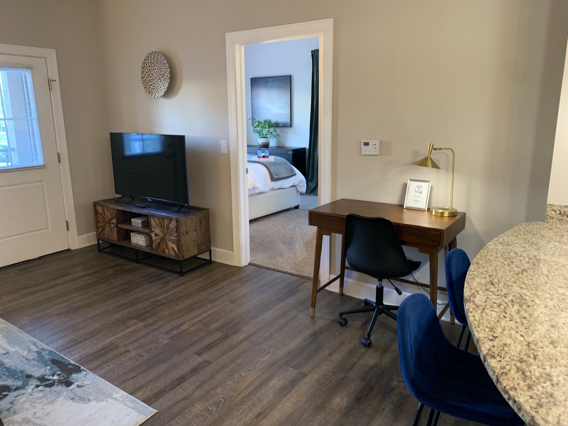 Living room with a smart tv, desk, and desk chair in a furnished apartment in Westerville Ohio