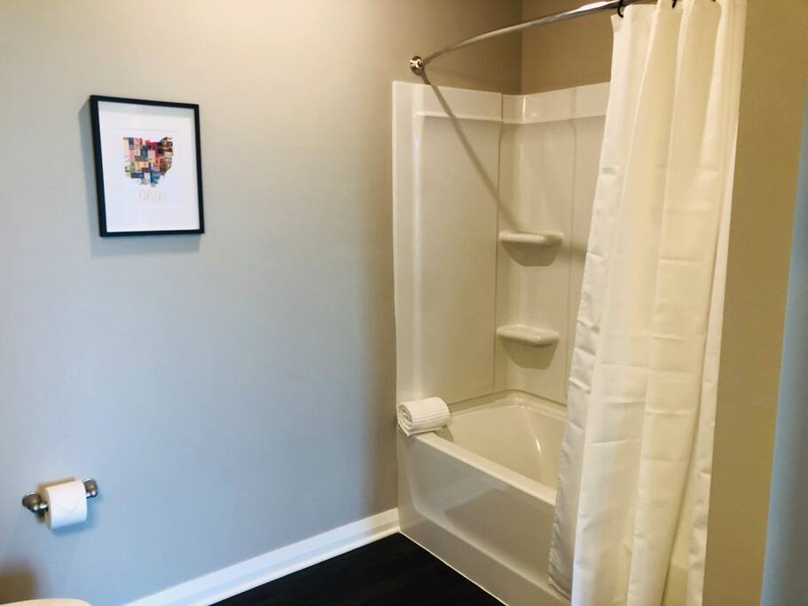 A shower and bath tub in a furnished apartment in Downtown Columbus