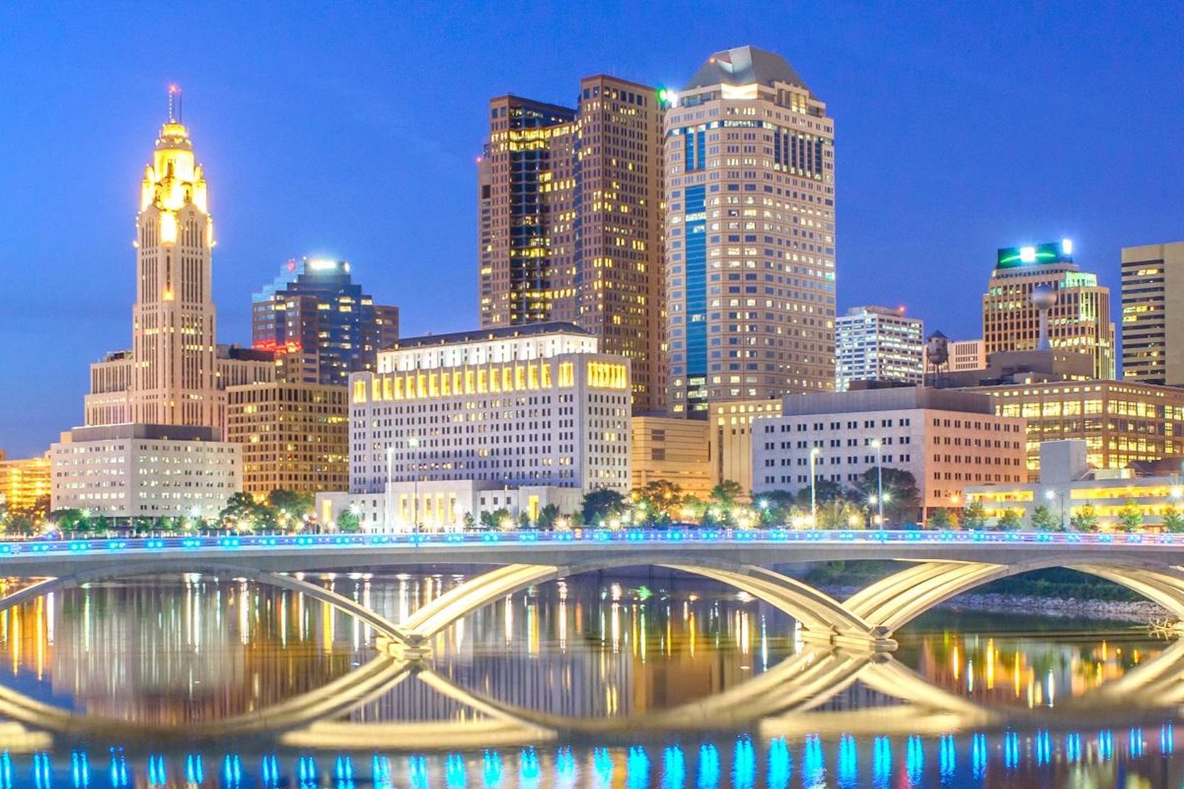 The city of Columbus Ohio at dusk lit up by lights