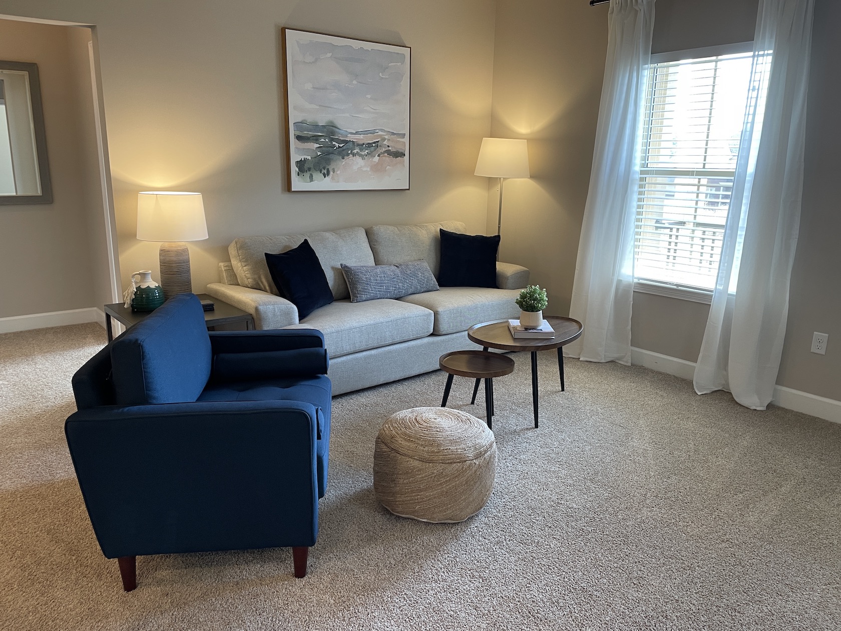 Living room with couch, coffee table and side chair in a furnished apartment near Westerville Ohio