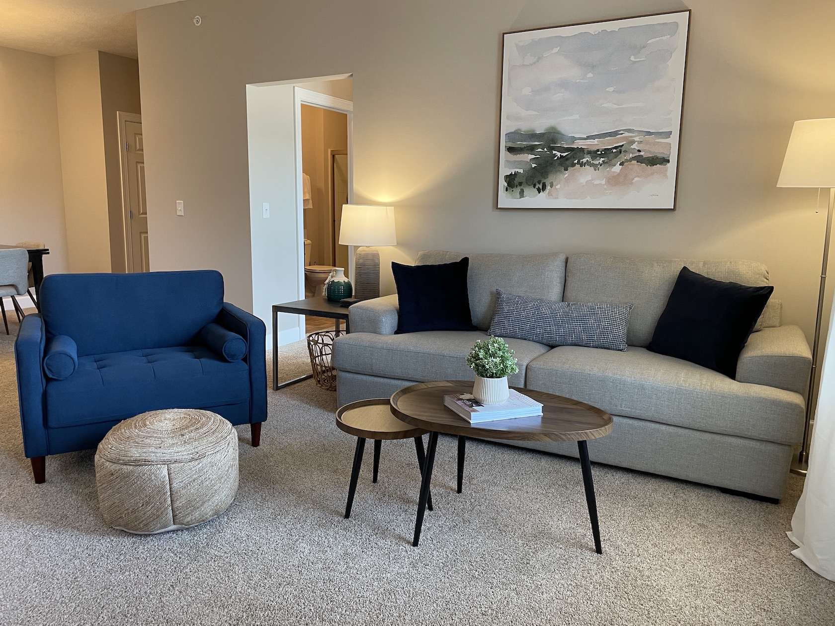 Living room with couch, coffee table and side chair in a furnished apartment near Westerville Ohio